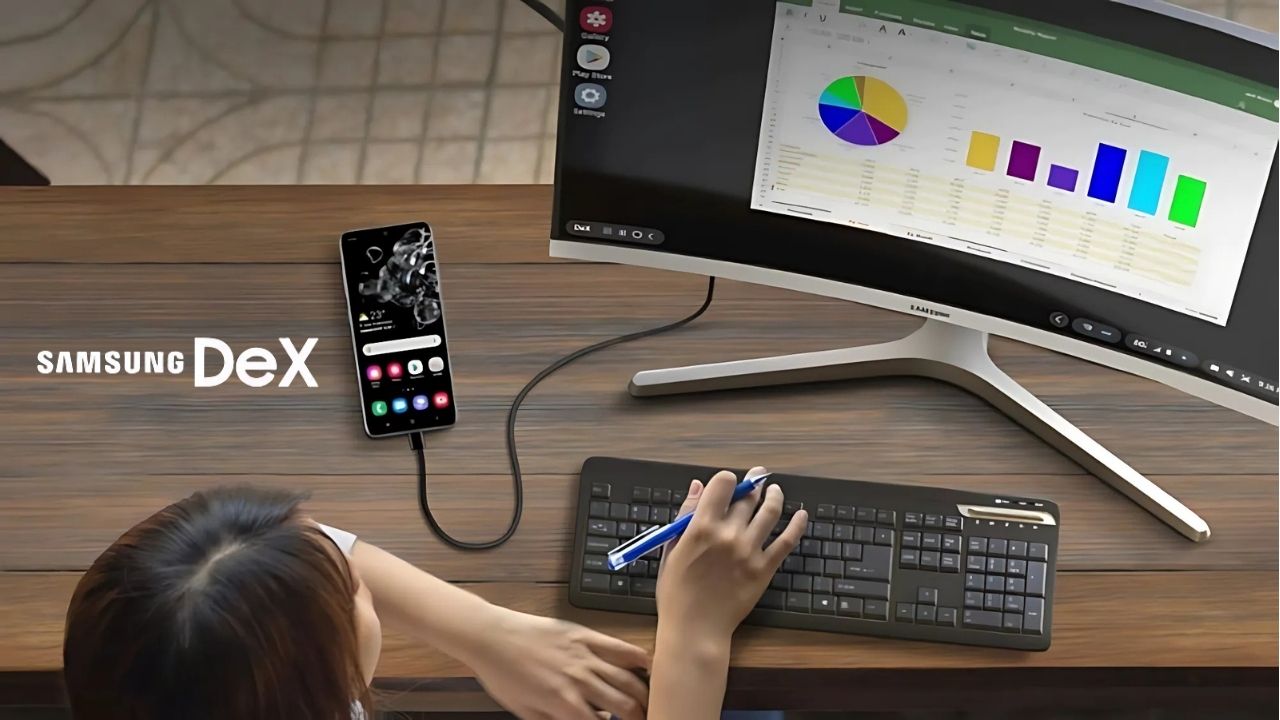 Person using Samsung smartphone connected to a monitor in DeX mode, showing a desktop workspace.